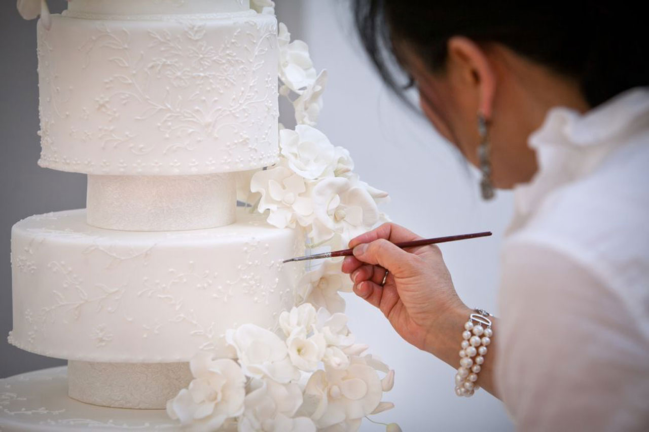 Wedding Cake Designer Ana Parzych Adding Final Brushed Embroidery Details to a Beautiful Cake