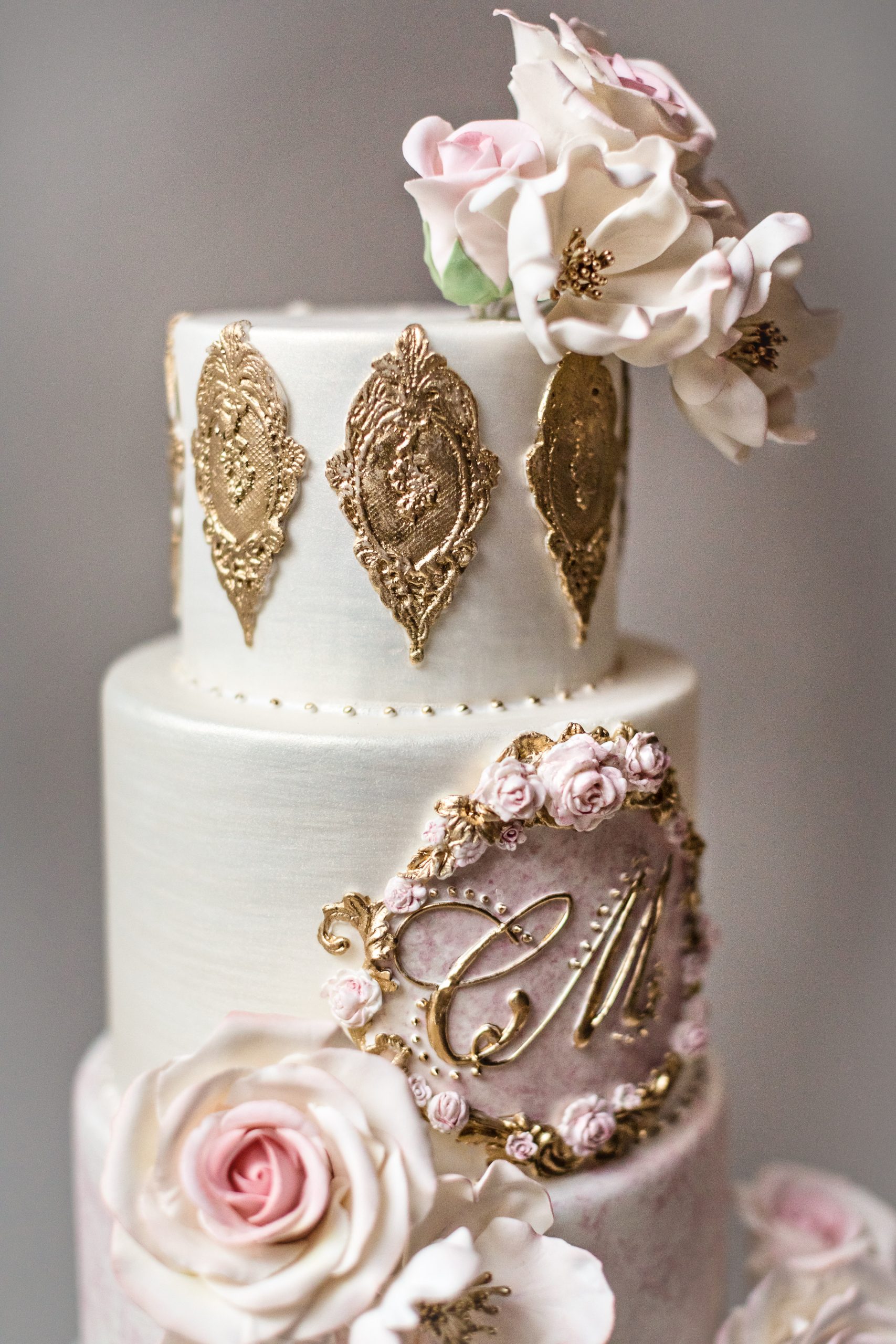 Amazing Vintage Custom Wedding Cake featuring gold lace and white and pink handcrafted sugar flowers. Luxury Wedding Cake by Master Sugar Artist Ana Parzych. CT, NYC, MA, RI.